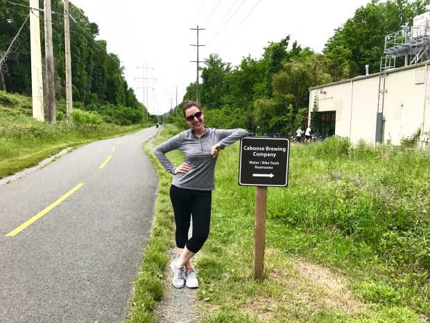 Marnay with the Caboose Brewing trail sign